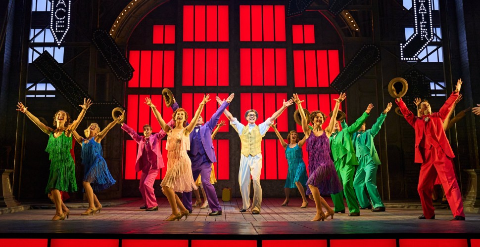 Performers dancing on stage during Singin' in the Rain musical